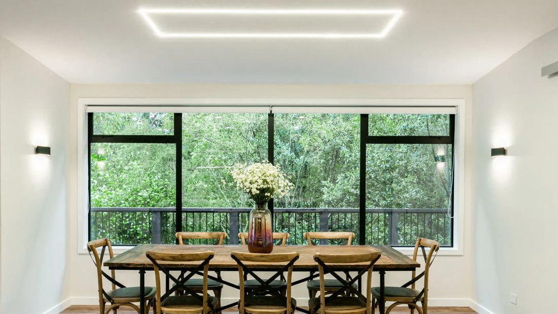 Dining area with large windows overlooking the deck