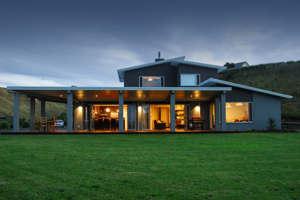 Modern Palmer Builders home lit up at dusk