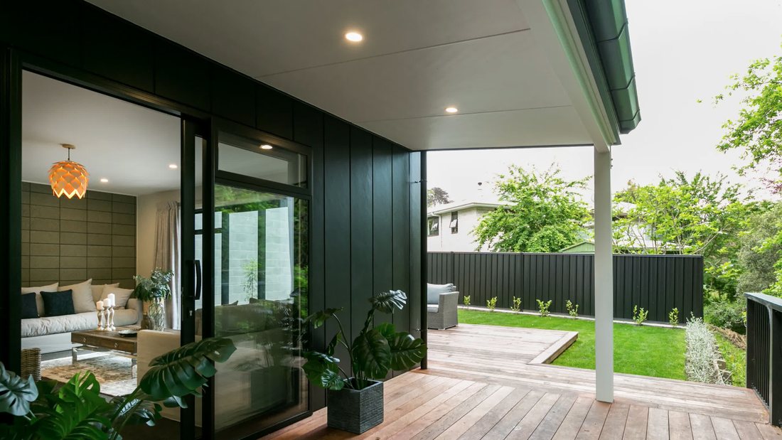 Lounge opening to a covered deck through wide doors
