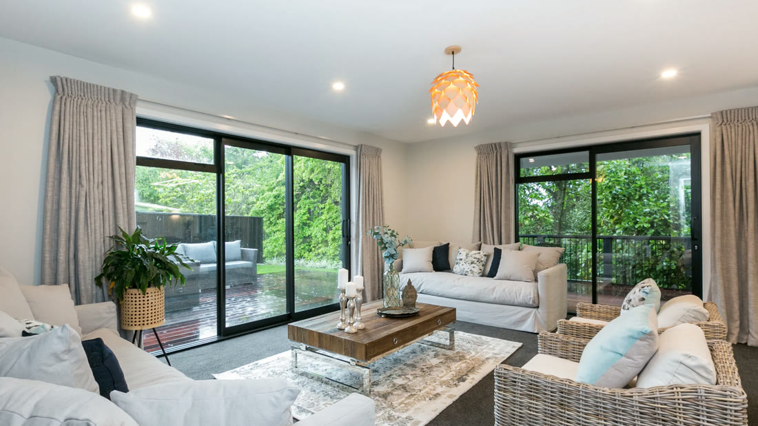 Lounge opening to a covered deck through wide sliding doors