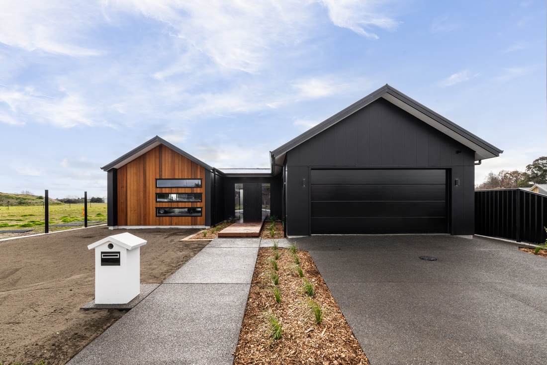 Dark-clad gabled home with double garage, built by Palmer Builders