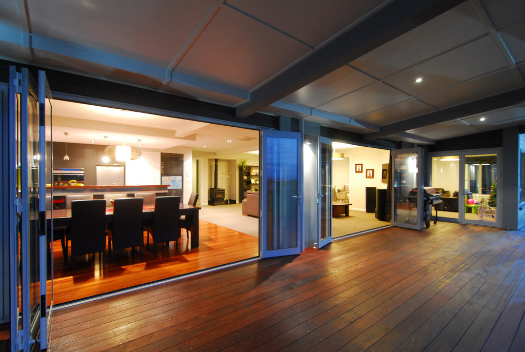 Open-plan living and dining with seamless deck access